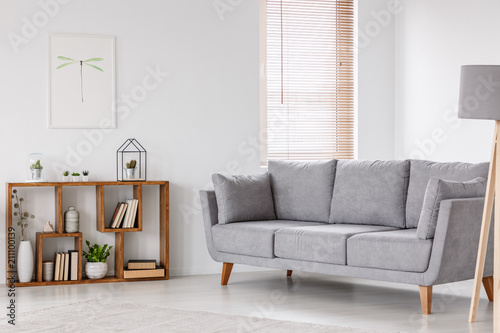 Fotografie Real photo of a scandi living room interior with gray settee standing near the w