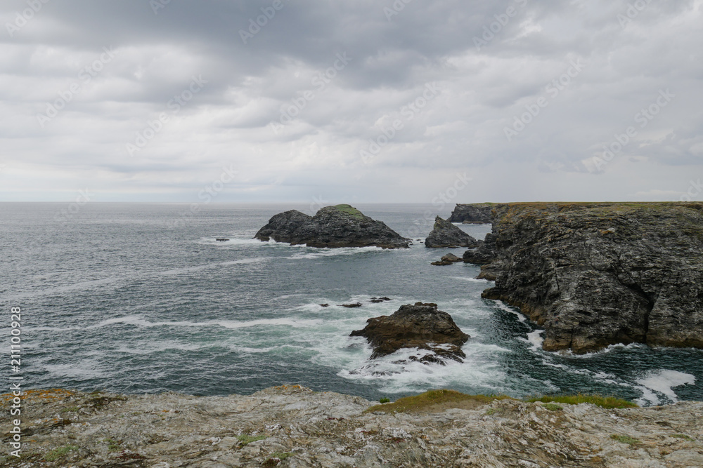 Typical brittany rocky coastline with grey cloudy sky and immensity of atlantic ocean, Belle Ile melancholic landscape