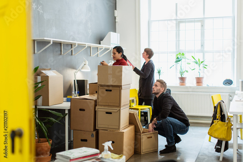 People handling boxes in office