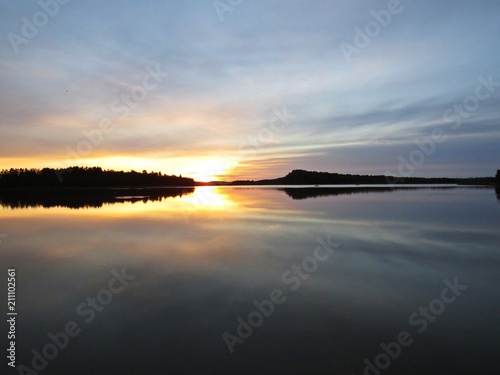 Sunset Over Beautiful Lake with Cloudy Sky in background