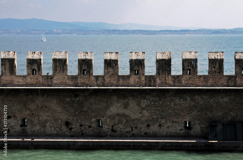 external wall of Sirmione Castle with Garda lake landscape