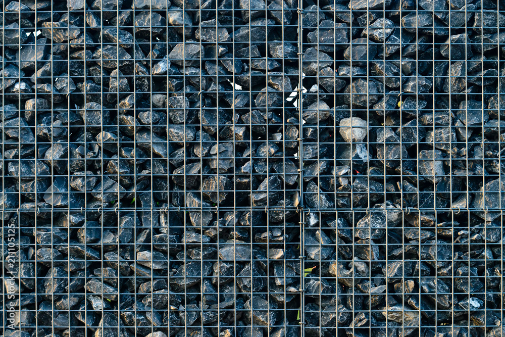 Fototapeta premium Background with crushed stones, elements, gravel in a metal grid