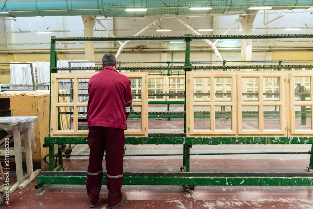 Manual worker doing his job at the woodworking factory. Environm