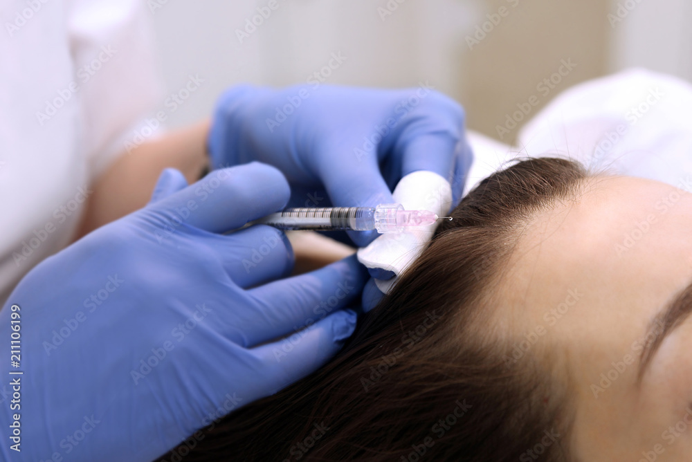 Doctor makes a shot in the scalp Doctor makes a shot in the scalp