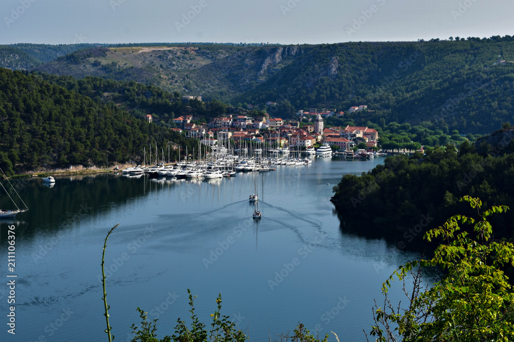 Town of Skradin on Krka river in Dalmatia, Croatia viewed from distance. Skradin is a small historic town and harbor