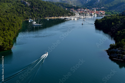 Town of Skradin on Krka river in Dalmatia, Croatia viewed from distance. Skradin is a small historic town and harbor