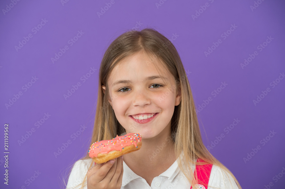 How tame childs sweet tooth. Kid rewarded for good behavior with sugary treats. Girl cute smiling face holds sweet donut. Girl likes sweets as donuts. Avoid rewards with sugar How tame childs sweet tooth. Kid rewarded for good behavior with sugary treats. Girl cute smiling face holds sweet donut. Girl likes sweets as donuts. Avoid rewards with sugar