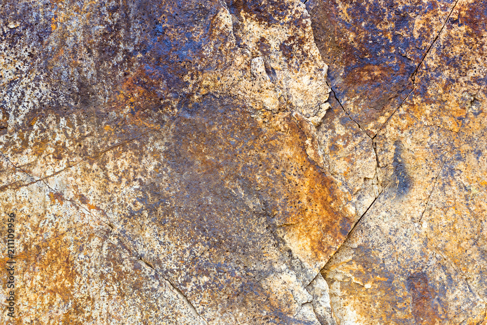 Brown stone texture. Rock formation with cracks and protrusions. Mountain of castle San Juan. Spanish beach resort Blanes in summertime, Costa Brava, Catalonia, Spain Brown stone texture. Rock formation with cracks and protrusions. Mountain of castle San Juan. Spanish beach resort Blanes in summertime, Costa Brava, Catalonia, Spain