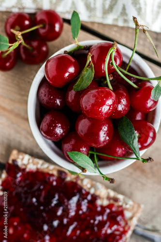 Fruity breakfast. Toast with cherry jam and fresh cherries.