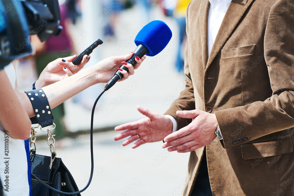 media reporter with microphone making journalist interview for news Stock  Photo