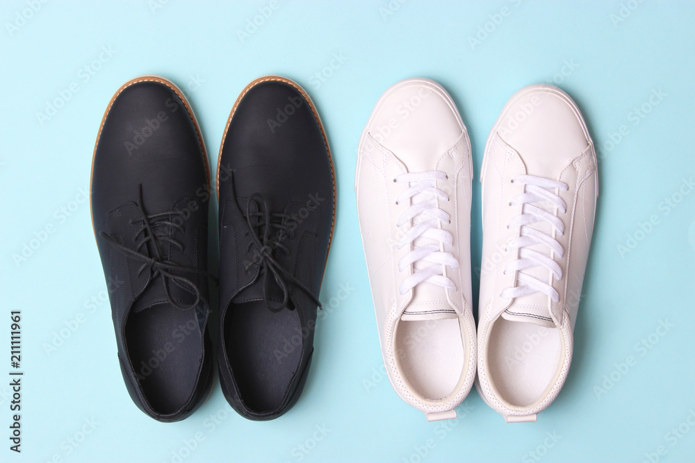 men's office shoes and sneakers on a colored background top view. men's shoes, choice.