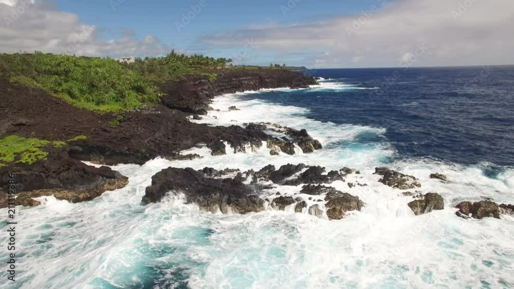 aerial shot of ocean coastline - waves washing up on a rock, Hawaii aerial shot of ocean coastline - waves washing up on a rock, Hawaii