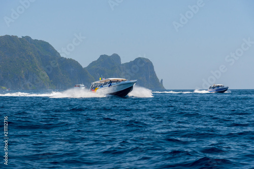 Motor boat and island in the sea