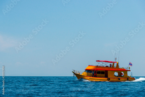 Motor boat and island in the sea