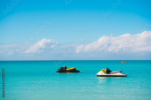 Extreme entertainment. Pair water scooter in turquoise ocean lagoon wait for extreme riding. Ocean beach st.johns resort equipped with modern water scooters for clients pleasure and fun. Water riding