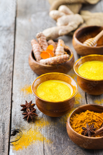 Traditional indian drink turmeric curcuma golden milk with ingredients