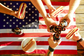 4th of July celebration party, young men hands holding beer bottle, holiday label design, Happy Independence day, hot dog, mustard, catchup. American flag, river recreation area. Close up, background
