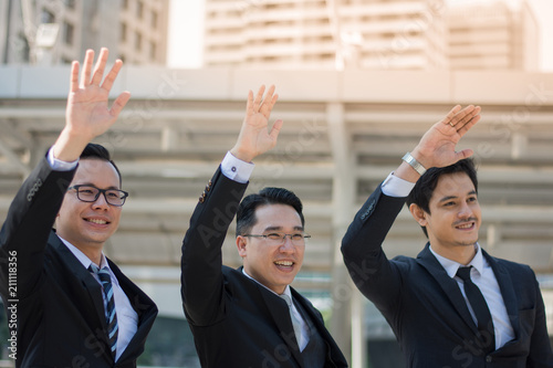 Businessmen are waving to greet