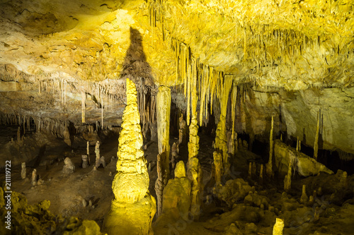 Mallorca, Many old stalagmite limestone formations touching stalagtites in caves of drach photo