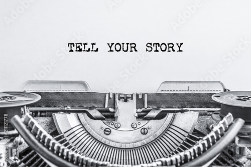 TELL YOUR STORY text typed on a vintage typewriter, old paper, Close-up. history