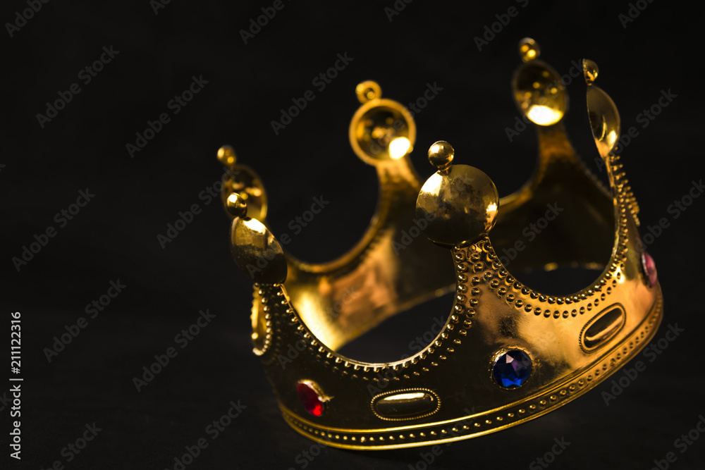 the golden crown of the king on a black background in the fall Stock Photo  | Adobe Stock