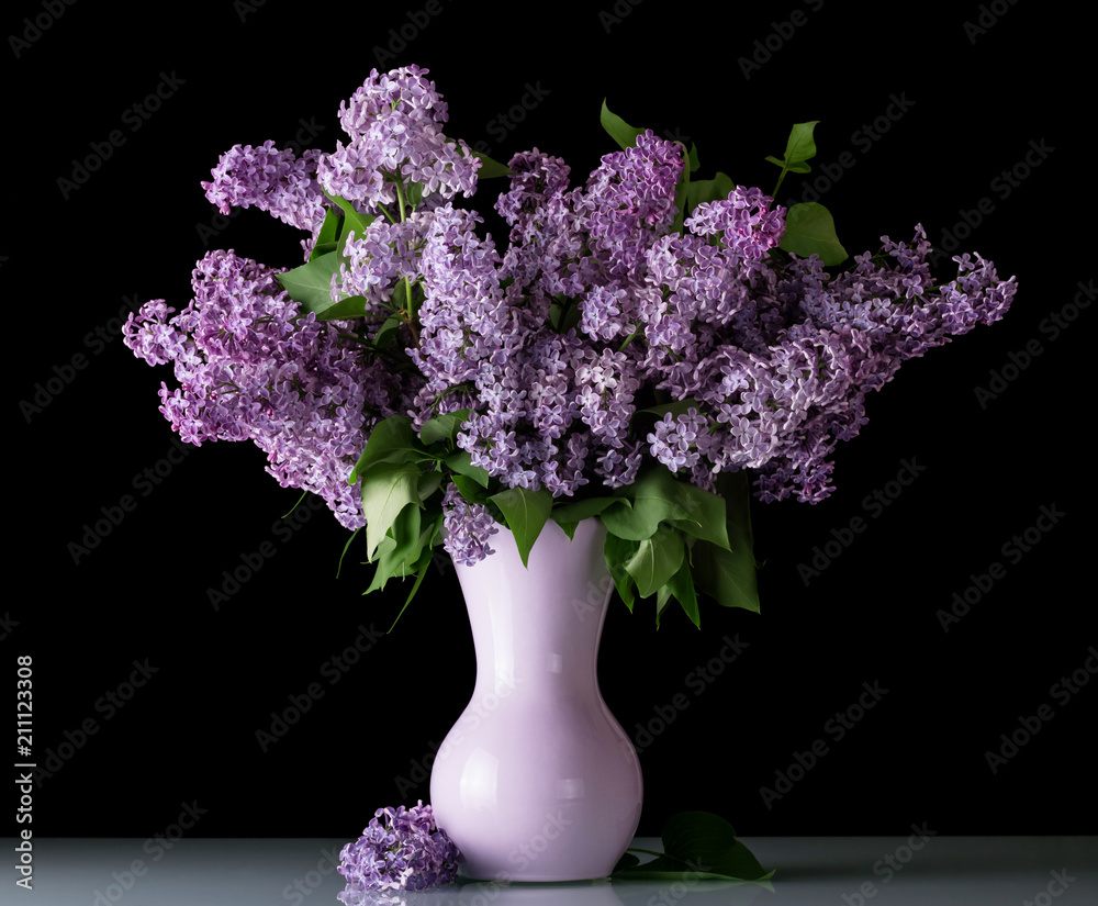 Fresh bouquet of lilac in vase isolated on black Fresh bouquet of lilac in vase isolated on black