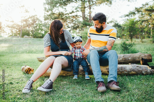 Hipster family, bearded dad with tattoos and stylish clothes. photo
