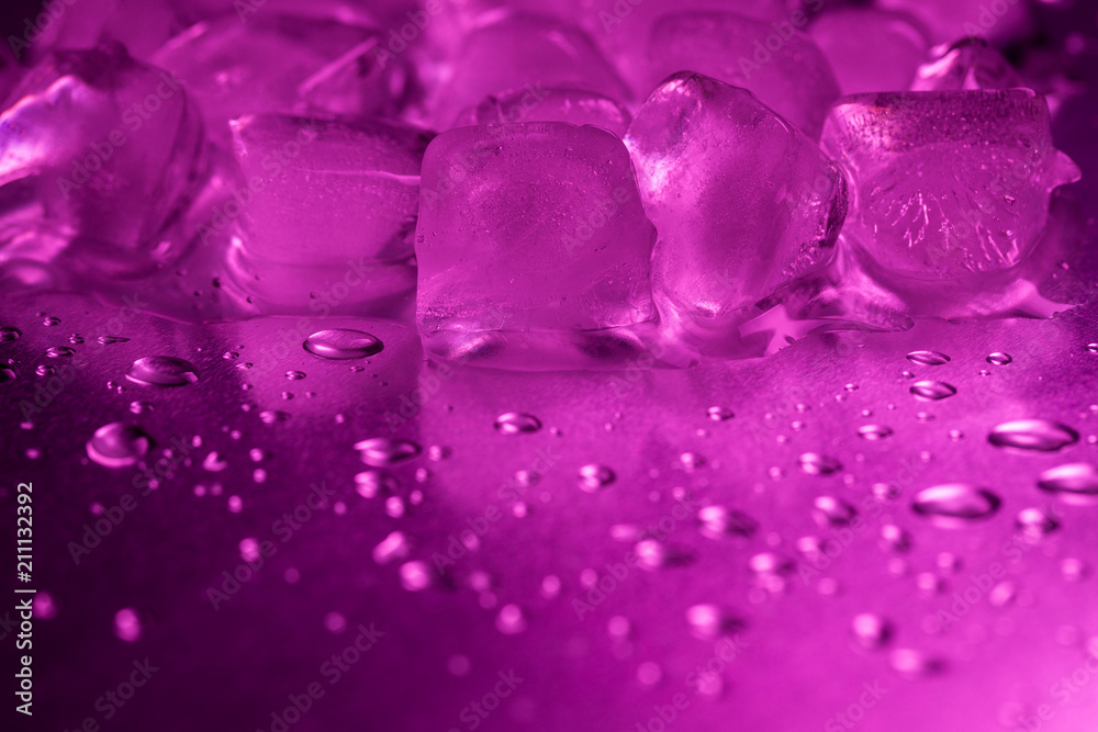 A pile of ice cubes in purple on a reflecting table A pile of ice cubes in purple on a reflecting table