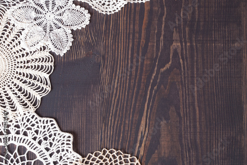 Vintage knitted lace on the background of wooden boards.