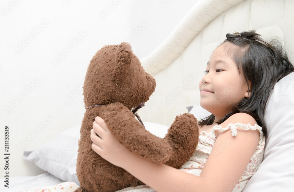 Cute girl is playing with a teddy bear Cute girl is playing with a teddy bear