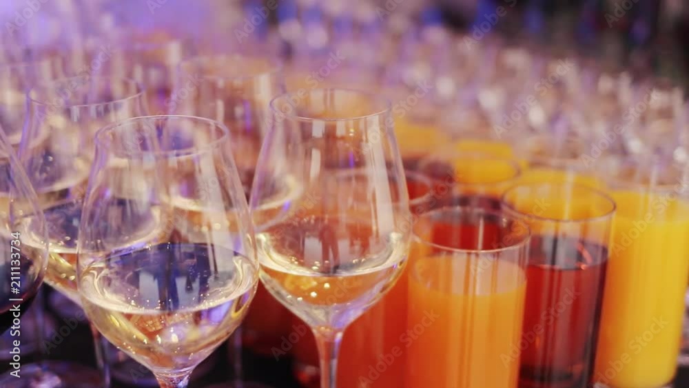 glasses of juice, wine and champagne on the table glasses of juice, wine and champagne on the table