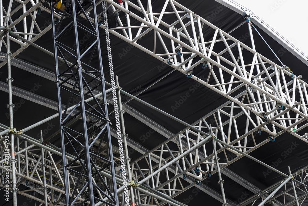 Background of metal construction of a portable concert stage with illuminators. 