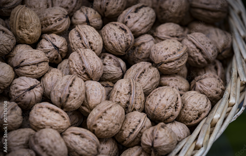 Background of a walnut in a wicker basket close-up Background of a walnut in a wicker basket close-up