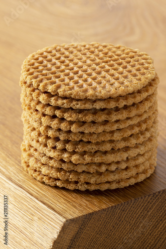 Wafers stacked in a pyramid on a wooden table. Copy space.