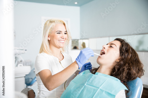 Female dentist examiming a patient