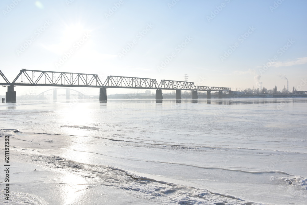 Fototapeta bridge on a frozen river on a sunny day