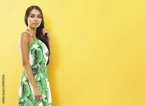 Woman on yellow wall and free space for your decoration. 
