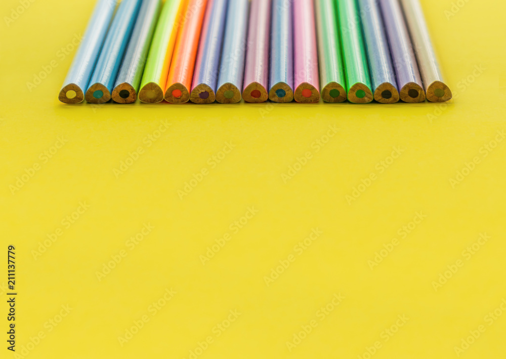 Diversity concept. row of mix color pencil on yellow background Diversity concept. row of mix color pencil on yellow background