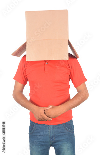 Young man gesturing with a cardboard box on his head isolated on white background © flowgics