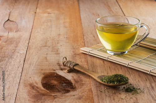 a cup of green tea on bamboo