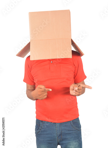 Young man gesturing with a cardboard box on his head isolated on white background