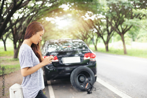 Asian woman using mobile phone while looking and Stressed man sitting after a car breakdown on street © tuiphotoengineer