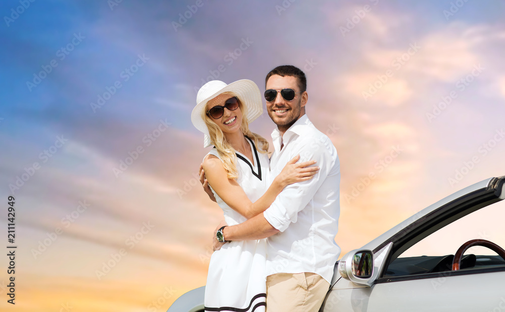 travel, love, date and people concept - happy couple hugging near convertible car over sky background travel, love, date and people concept - happy couple hugging near convertible car over sky background