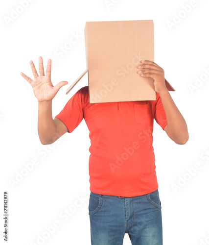 Young man gesturing with a cardboard box on his head isolated on white background