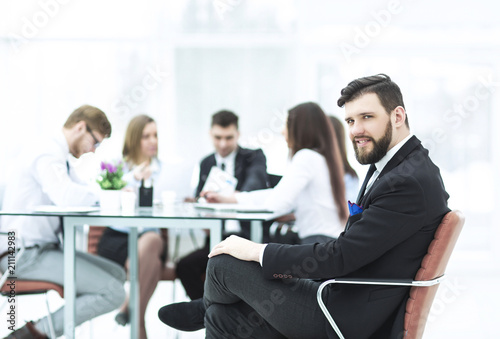  Manager of the company on the background of the working meeting the business team
