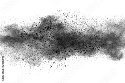 Black powder explosion against white background.Closeup of black dust particles explode isolated on white background. photo