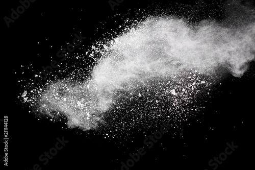 Bizarre forms of white powder explosion cloud against dark background. Launched white particle splash on black background.