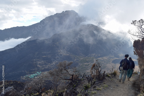 Mount Meru partly covered by clouds seen from the top of Little Meru, Arusha National Park, Tanzania  photo