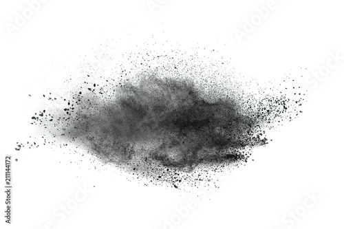 Black powder explosion against white background.Closeup of black dust particles explode isolated on white background.