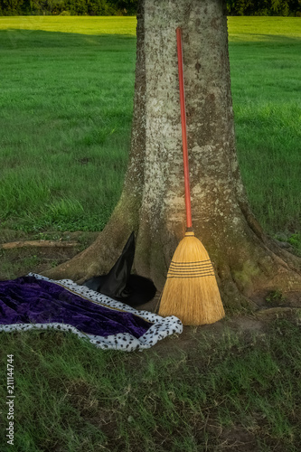 Witch's hat, cape and broom in a parking lot at a local park. photo